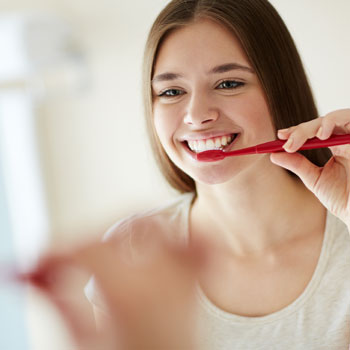 A Woman brushing her teeth