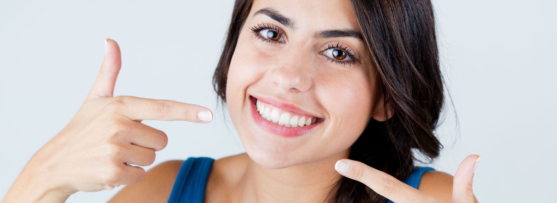 Woman pointing at her teeth